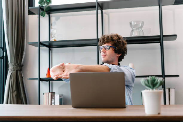 istock Businessman working with computer laptop, stretch oneself or lazily for relaxation 1453250856