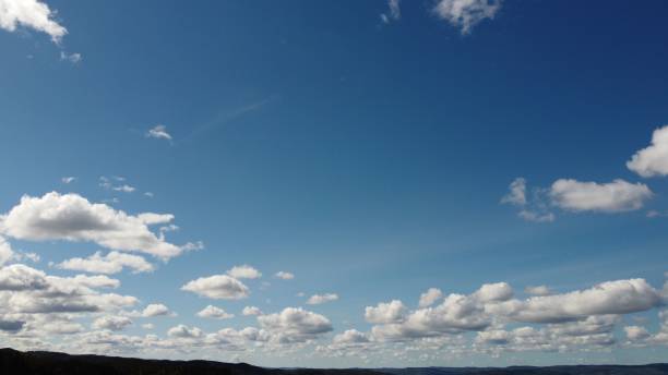 istock Fluffy white clouds in the blue sky 1453255319