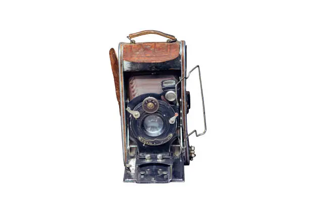 Old camera on a vintagephotograph, isolated on a white background
