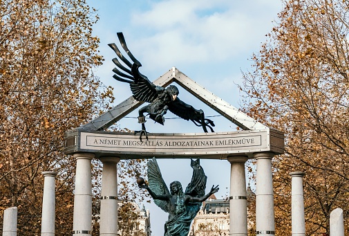 Budapest, Hungary – November 30, 2021: The Memorial for Victims of the German Occupation with stone statues of the Archangel Gabriel and an eagle