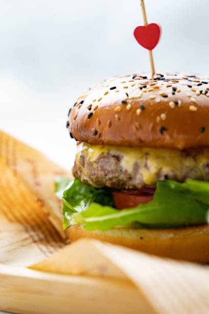 istock Vertical shot of a fresh hamburger on the blurry background 1453257015