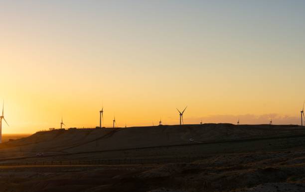 istock Silhouette shot of windmills on a grass field under a gradient sunset sky 1453257410