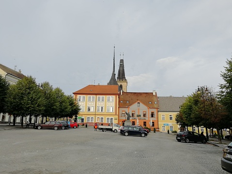 The historical city center and town square of Louny, Czech Republic, with parked cars