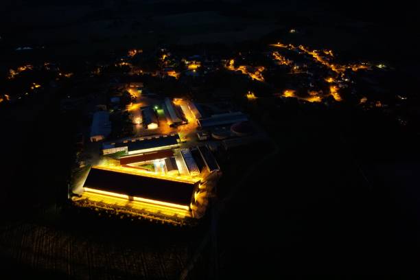 istock Aerial view of  an illuminated cowshed at night 1453258126