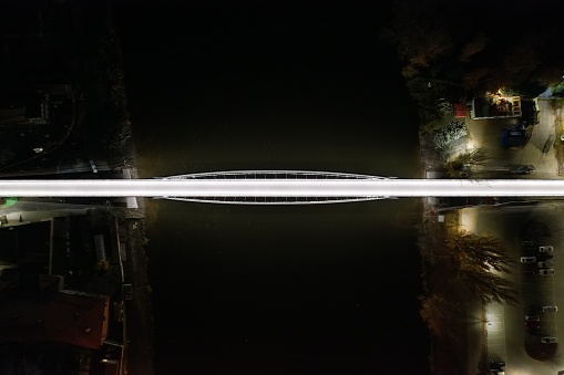 A top view of an illuminated bridge across the Elbe River in Nymburk at night, Czech Republic