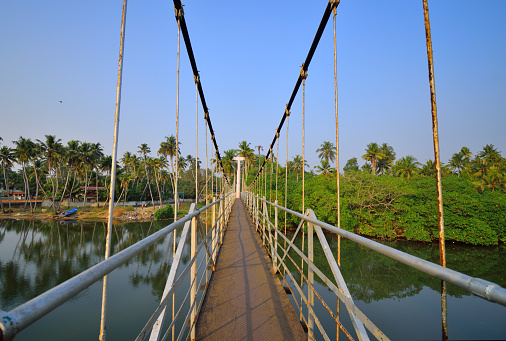 A hanging bridge over Parvathi Puthannaar, a man-made canal in Trivandrum District.