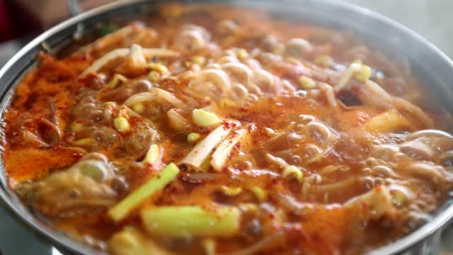 Closeup of delicious noodles cooking with spices and vegetables in a pot shot in HD