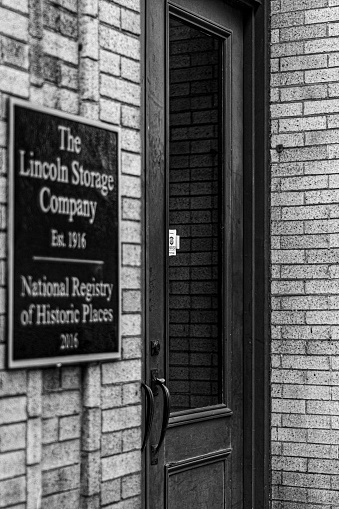 Dayton, United States – May 30, 2022: A vertical grayscale shot of The Lincoln Storage Company sign on the building wall in Dayton, Ohio