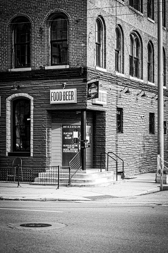 Dayton, United States – May 30, 2022: A vertical grayscale shot of FOOD-BEER restaurant sign on the building wall in Dayton, Ohio