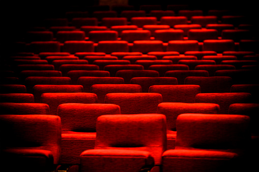 Empty red cinema chairs, red seats. Dark tone