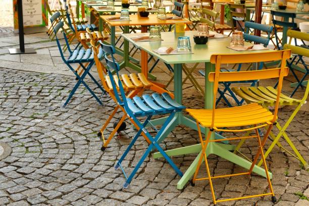 istock Empty colorful chais and tables at an outdoor cafe on a sidewalk 1453269276