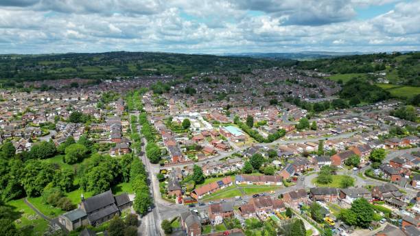 istock Aerial view of cityscape surrounded by growing trees and greenery fields under blue bright sky 1453269561