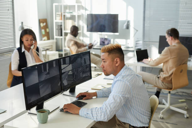 istock Asian young man looking at surveillance camera feed 1453276443
