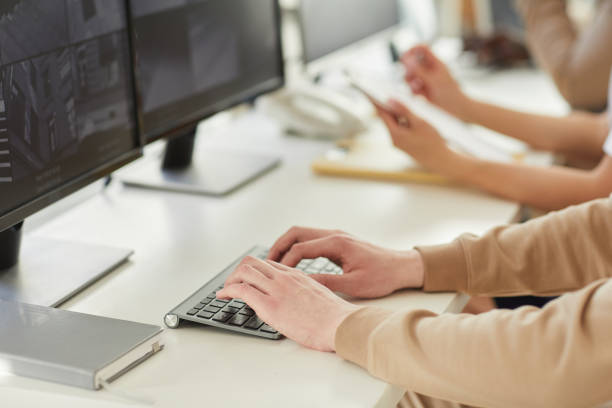 istock Close up male hands typing on keyboard 1453276461