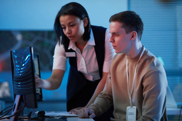 istock Two young people looking at surveillance camera footage 1453276512