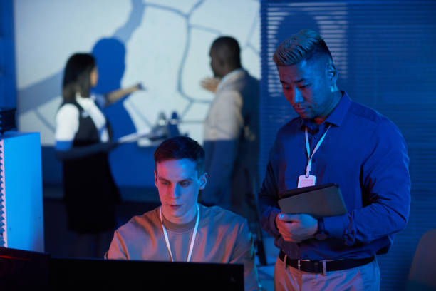 istock Two people working in mission control center 1453276523