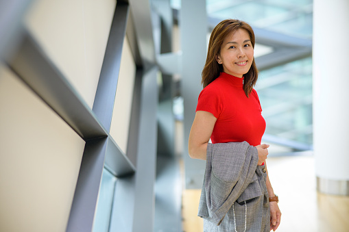 Shot of a confident Asian businesswoman working in a modern office. Looking at camera