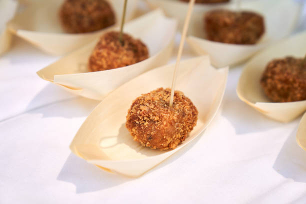 one cocido croquette with a toothpick in single portion stock photo