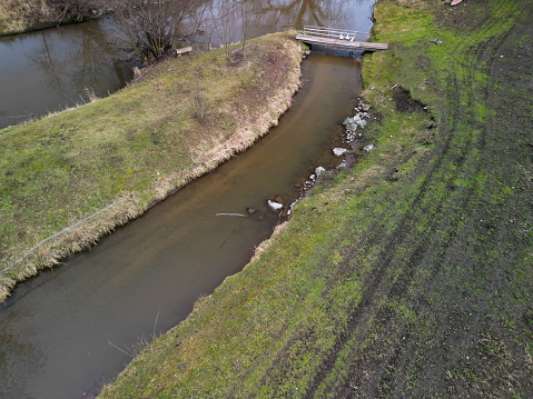 flooded stream led to a narrow riverbed where the water drains quickly, the bends must be laid out with a stone so that water erosion does not damage them water pipeline supplies water flood flooding, break water, creek, bottom