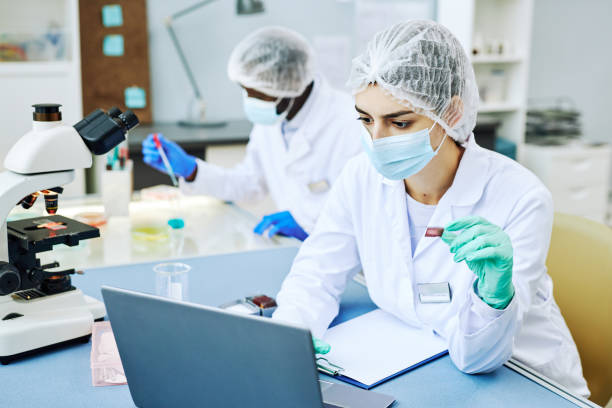 istock Young Middle Eastern woman working in modern laboratory and doing blood tests 1453276919