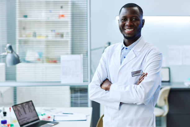 istock Smiling black man standing in laboratory 1453277193