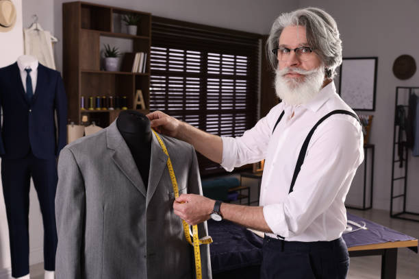 istock Professional tailor with measuring tape working in atelier 1453279111