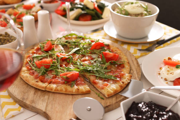 Pizza and many different dishes served on buffet table for brunch