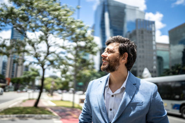 istock Businessman contemplating  in a financial district 1453280361