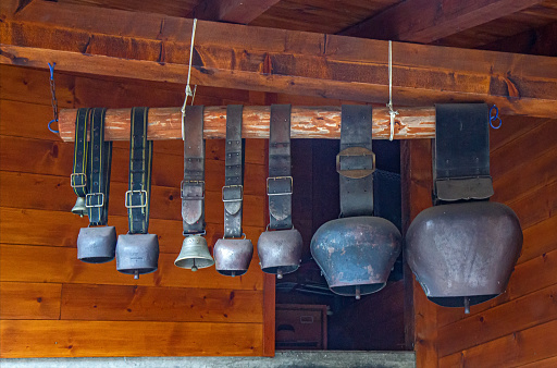 Group of cowbells on the terrace of the traditional house in the Switzerland Alps