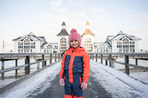 Caucasian girl in front of the Sellin pier, during winter day