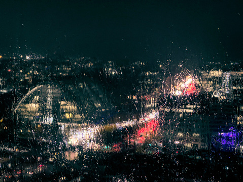 City lights through a rainy window at night