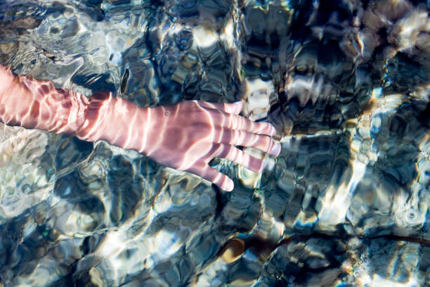 istock reflection of sun rays in the sea with water bubbles 1453286475