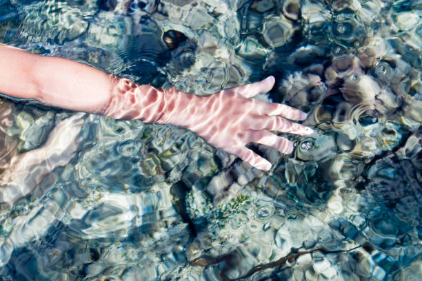 istock reflection of sun rays in the sea with water bubbles 1453286478