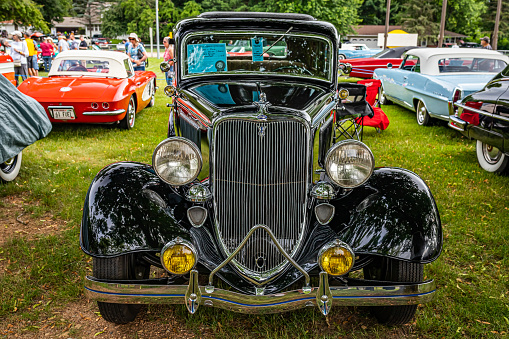 Iola, WI - July 07, 2022: High perspective front view of a 1933 Ford Model 40 Deluxe Fordor Sedan at a local car show.