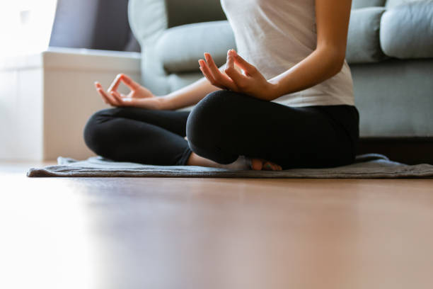 istock Crop unrecognizable young woman doing yoga at home 1453289533