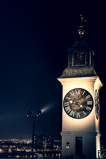 Famous clock tower at night. Clock tower on Petrovaradin fortress. It has reverse mechanism. Big needle shows hours and small needle minutes.