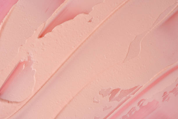 istock Pink cosmetic clay smudged background. Pink cosmetic texture macro background. 1453290579