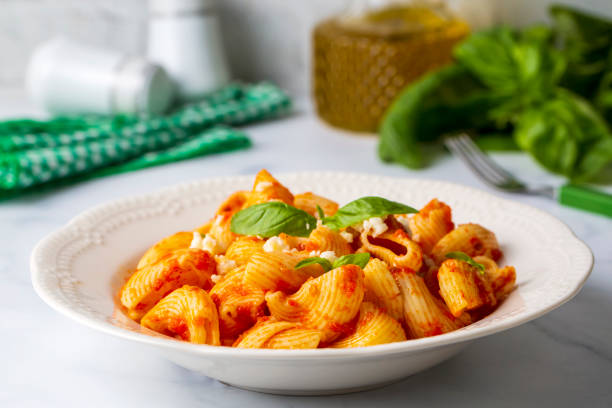 istock Tomato ravioli pasta or pipe rigate shaped pasta on the cheese 1453290618