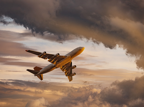 Cargo Jet airplane taking off at sunset