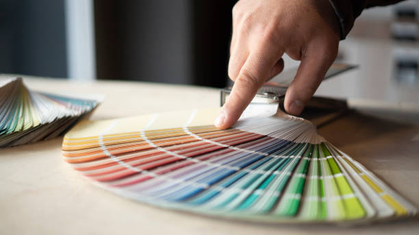 istock Man choosing house wall paint color 1453291995