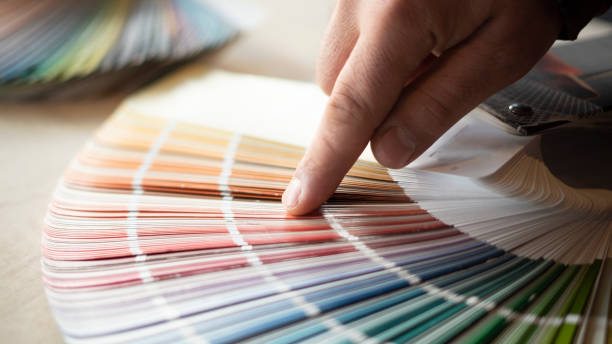 istock Man choosing house wall paint color 1453292059