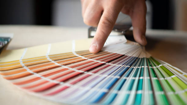 istock Man choosing house wall paint color 1453292060