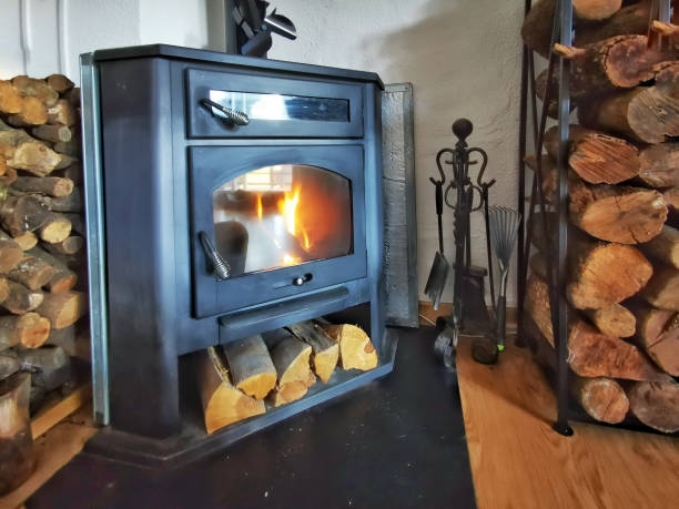 a glass fired wood stove stock photo