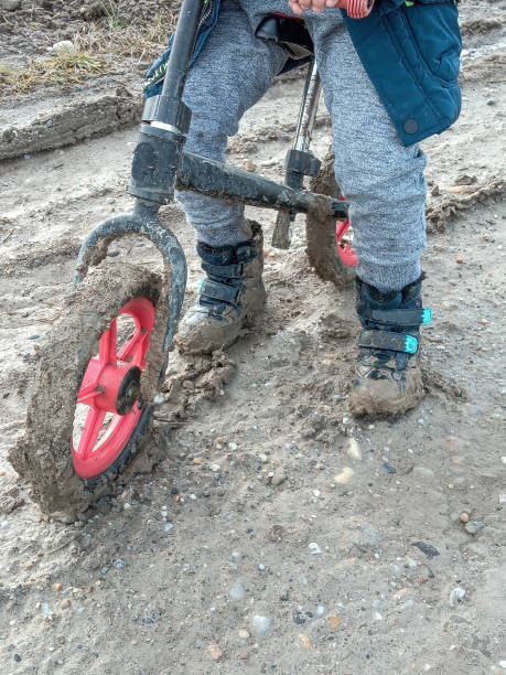 istock A Romanian boy plays with his bicycle through the mud 1453293157