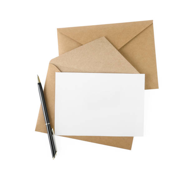 istock Brown envelopes, blank letter and pen isolated on white, top view 1453293834