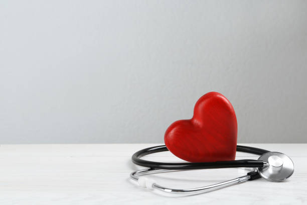 istock Stethoscope and red heart on white wooden table, space for text. Cardiology concept 1453293983