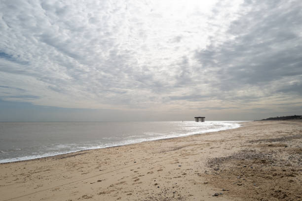 Empty Suffolk beach seen with an old WW2 gun placement. stock photo