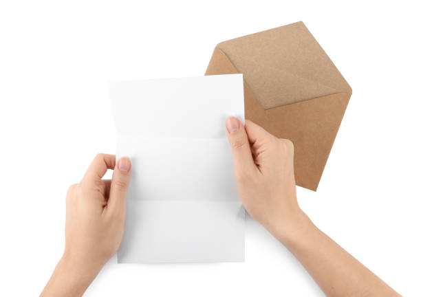 istock Woman holding blank letter on white background, top view 1453295167