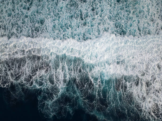 istock Droneshot of waves at a beach with black sand. 1453295208