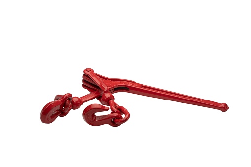 A metallic red ratchet chain binder for securing the load isolated on the white background